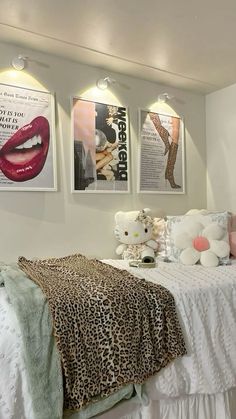 a bedroom with posters on the wall and a bed in front of it's headboard