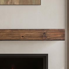 a fireplace with two wooden shelves above it