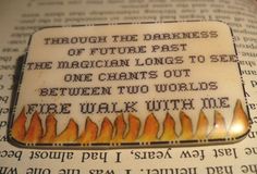 a close up of a book with a piece of paper on it that says through the darkness of future past, the magician longs to see between two worlds free walk with me