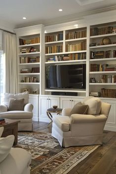 a living room filled with lots of white furniture and bookshelves full of books