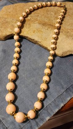 Vintage Avon Necklace. Pink and gold beads. Approximately 18 inches. Formal Gold Necklaces With 8mm Beads, Vintage Gold Jewelry With 8mm Beads, Vintage Gold Beaded Necklaces With 8mm Beads, Gold Single Strand Beaded Necklace For Costume Jewelry, Gold Single Strand Beaded Costume Necklace, Gold Necklace With 16 Inch Round Beads, Avon Jewelry, Vintage Avon, Beaded Necklaces