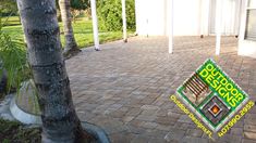 an image of a brick patio with trees in the foreground and a sign on the ground