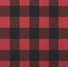 a red and black checkered fabric with a ruler in front of the plaid pattern