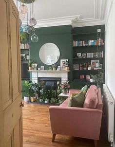 a living room filled with furniture and a fire place next to a book shelf full of books