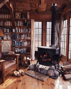 a living room filled with furniture and a fire place in the middle of a book shelf