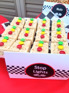 a box filled with lots of treats sitting on top of a red table covered in candy