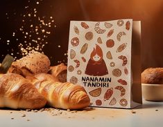 there are many croissants on the table next to each other and a bag that says namami tandiri