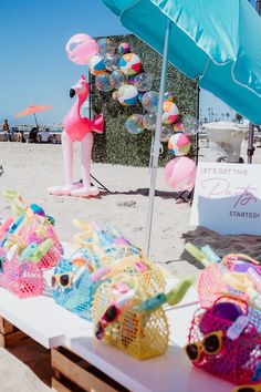 several beach toys on a table under an umbrella