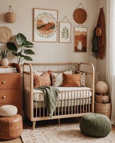 a baby's room with a crib, rugs and pictures on the wall