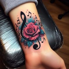 a rose and music notes tattoo on the arm