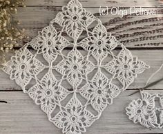 crocheted doily on wooden background with flowers