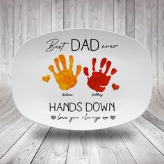 a plate with two handprints on it and the words best dad ever written in red