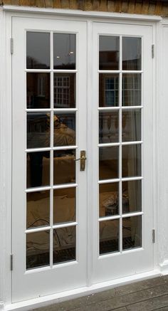 a white double door with glass on the outside