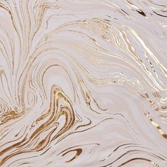 an abstract marble pattern with gold and white colors