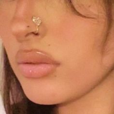 a close up of a person with a nose piercing