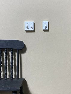 a chair and two light switches on a wall