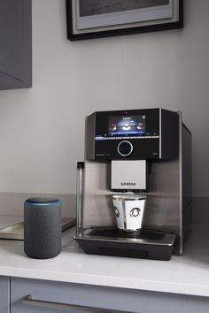 an automatic coffee maker sitting on top of a counter