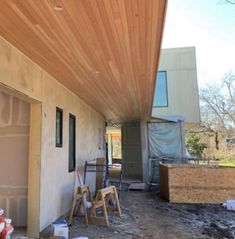 the outside of a house being built with wood planks on the roof and walls