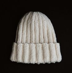 a white knitted hat on a black background