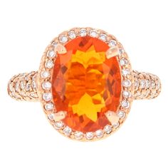 This ring has a 3.30 carat Oval Cut Fire Opal in the center of the ring and is surrounded by 66 Round Cut Diamonds that weigh a total of 0.73 carats. The total carat weight of the ring is 4.03 carats. The Orange Mexican Fire Opals are considered very valuable and this ring makes the fire opal magnificently stand out. It measures at approximately 11 mm x 14 mm and is a beautiful clean stone with lots of fire. The ring is articulately casted in 14K Rose Gold and weighs approximately 7.3 grams. The ring is a size 7 and can be re-sized if needed. Yellow Gold Cocktail Ring, Fire Opals, Ring Rosegold, Art Deco Diamond Rings, Opal Ring Gold, Jewels Rings, Gold Cocktail Ring, Gold Cocktail, 14k Rose Gold Ring