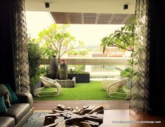 a living room filled with furniture next to a lush green yard