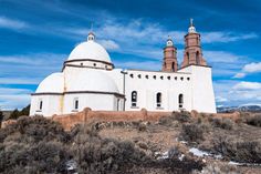 a large white building with two towers on top of it's sides in the desert