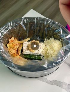 a plastic container filled with food on top of a table