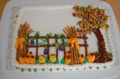 a decorated cake on a white plate sitting on a table