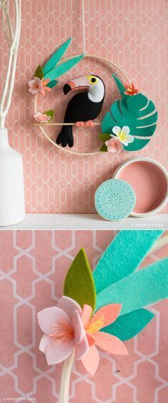 paper flowers are placed on the shelf next to a vase with a bird in it