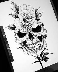 a black and white drawing of a skull with flowers on it's head, next to an iphone