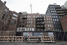 an abandoned building with construction barricades around it