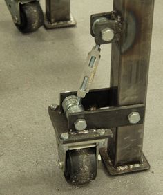 a machine that is sitting on the ground with wheels attached to it's sides