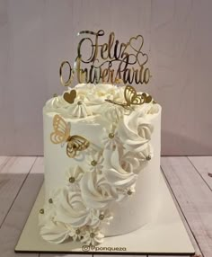 there is a white cake with gold butterflies on it and the words hello to you