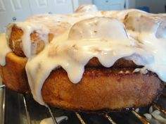 a close up of some kind of food on a metal rack with white icing