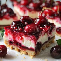 a piece of cheesecake with cherries on top