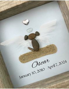 a wooden frame with an angel ornament in the shape of a mouse on it