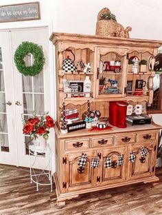 a wooden china cabinet sitting on top of a hard wood floor