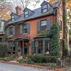 an old brick house with ivy growing on it