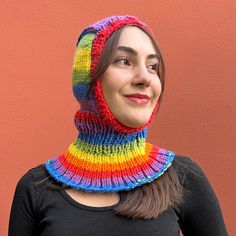 a woman wearing a multicolored knitted neck warmer