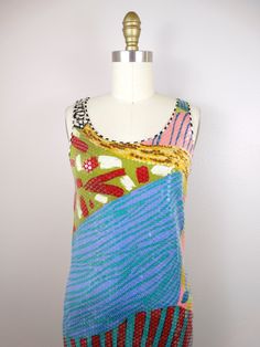 "This is such a rare dress from Missoni. It's fully embellished with clear sequins on silk with a funky abstract design. It's in excellent condition! Measurements: (note, there's a little stretch in the material) Bust - 32-36\" Waist - 30-34\" Hips - 36-40\" Total Length - 39\" This dress comes from a pet-free and smoke-free home. If you would like more info or have any questions, please don't hesitate to ask!" Embellished Multicolor Sequin Dress For Summer, Embellished Multicolor Sequin Summer Dress, Multicolor Embellished Sequin Summer Dress, Multicolor Embellished Sequin Dress For Summer, Fitted Multicolor Sequin Fabric For Summer, Spring Embellished Multicolor Sequin Fabric, Multicolor Summer Dress With Mirror Work, Fitted Silk Sequin Dress, Fitted Summer Dress With Mirror Work