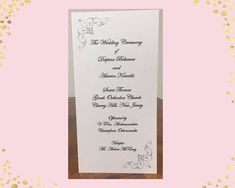 the wedding program is displayed in front of a pink background