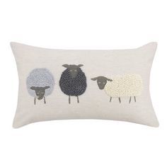 three sheep on a white linen pillow