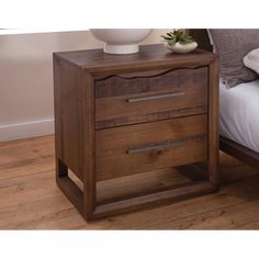 a wooden night stand with two drawers and a white bowl on the nightstand next to it