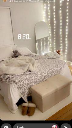 a bedroom with lights on the wall and a bed in the foreground that has an animal print comforter