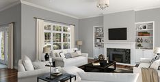 a living room filled with furniture and a flat screen tv mounted on the wall above a fireplace