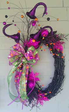 a purple and green wreath hanging on the wall