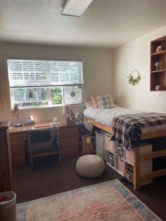 a bedroom with a bed and desk in it