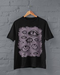 Thanks for stopping by! Grunge Eyes T-shirt Printed on a super soft, cotton tee Dispatched in 5 working days or sooner Unisex Free UK delivery Material: 100% ringspun cotton. Chest (to fit): S  34/36   M  38   L  40/42   XL  44/46   XXL  48/50 ECO-FRIENDLY Each garment is made to order, reducing extra material and energy that would be otherwise wasted We use DTG printing process which is easier on the environment than screen-printing Our ink is bright and also eco-friendly. Do not tumble dry. Wa Punk Halloween Anime Print Top, Halloween Punk Anime Print Tops, Punk Anime Print Halloween Top, Emo Black T-shirt With Graphic Design, Black T-shirt With Sublimation Print For Alternative Fashion, Emo Halloween T-shirt For Streetwear, Halloween Anime Print Grunge T-shirt, Emo Anime Print Tops For Halloween, Black Alternative T-shirt With Anime Print