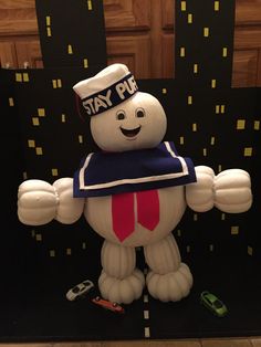 a large inflatable toy with a hat on it's head and arms