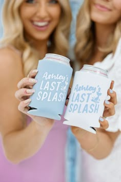 two beautiful women holding up cans of last splash and another one is smiling at the camera